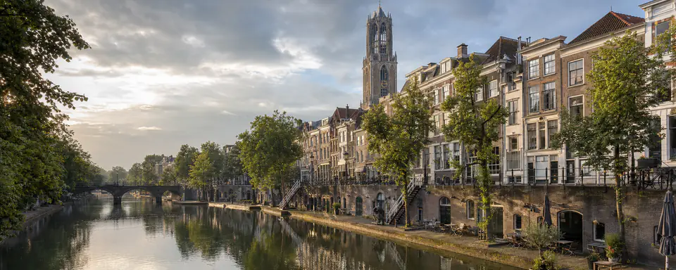 Illustrated view of Utrecht's Oudegracht with wharf cellars, historic houses, and the Dom Tower