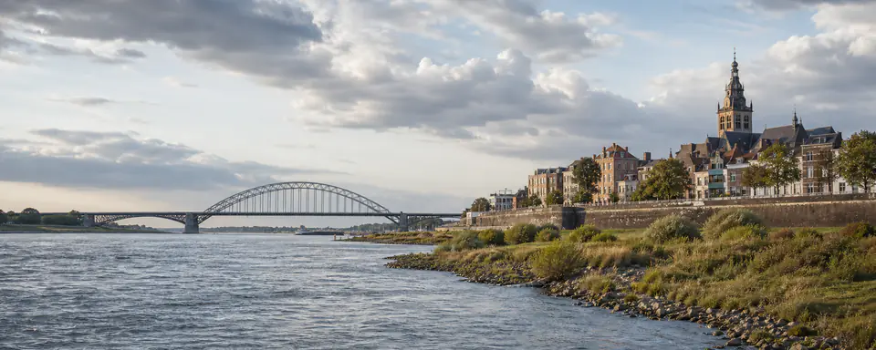 Illustrated view of Nijmegen on the Waal with the Waal Bridge and historic city on the river bluff