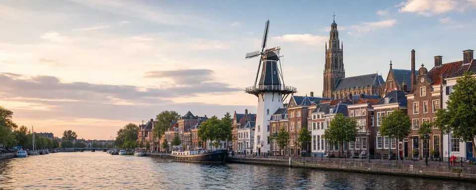Illustrated view of Haarlem on the Spaarne with a windmill, historic houses, and a church tower